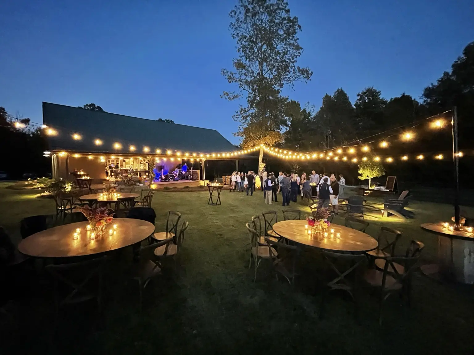 Evening gathering under string lights at Twenty 20 Farms